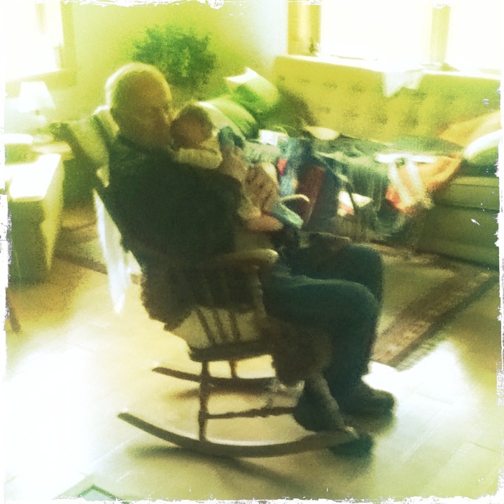 Man in rocking chair with baby