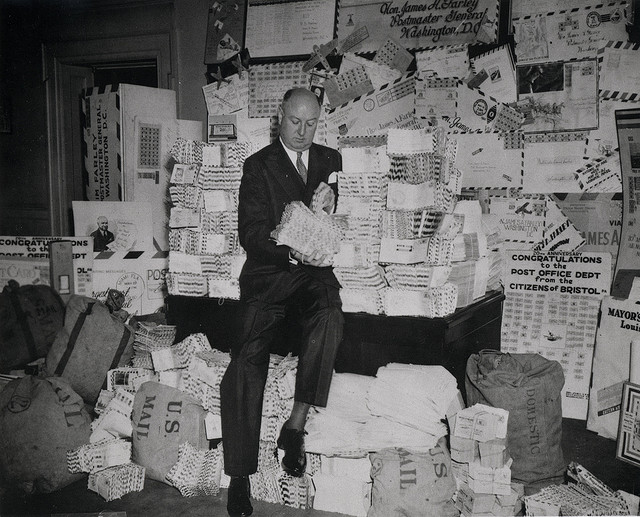 Man surrounded by piles of mail