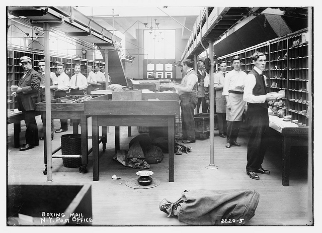 Postal workers sorting mail