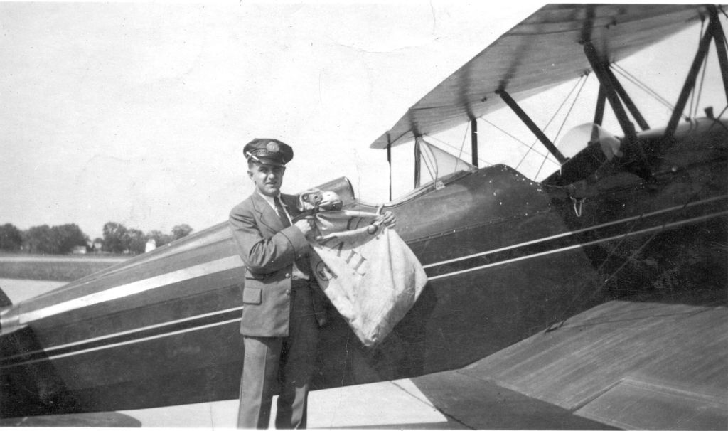 Marion Smykowski loading airmail into airplane